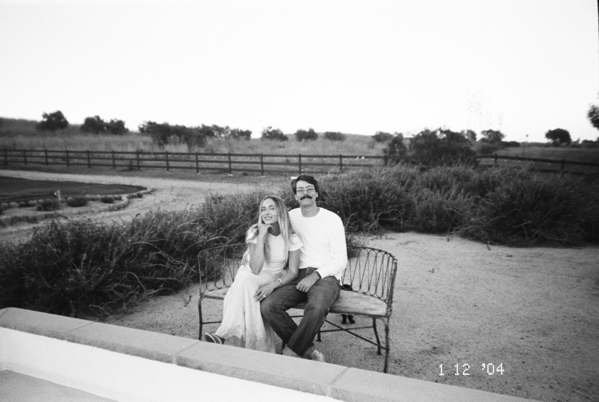 Oliver and Tiana sitting in long grass